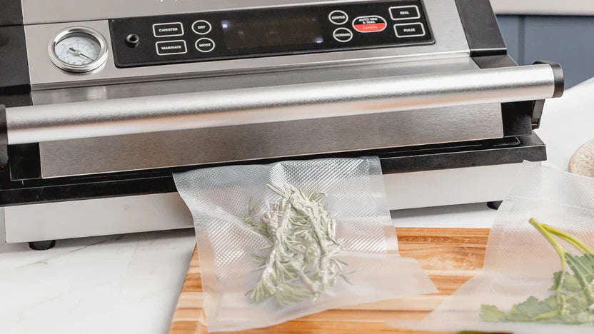 Vacuum sealing fresh rosemary with countertop vacuum sealer machine