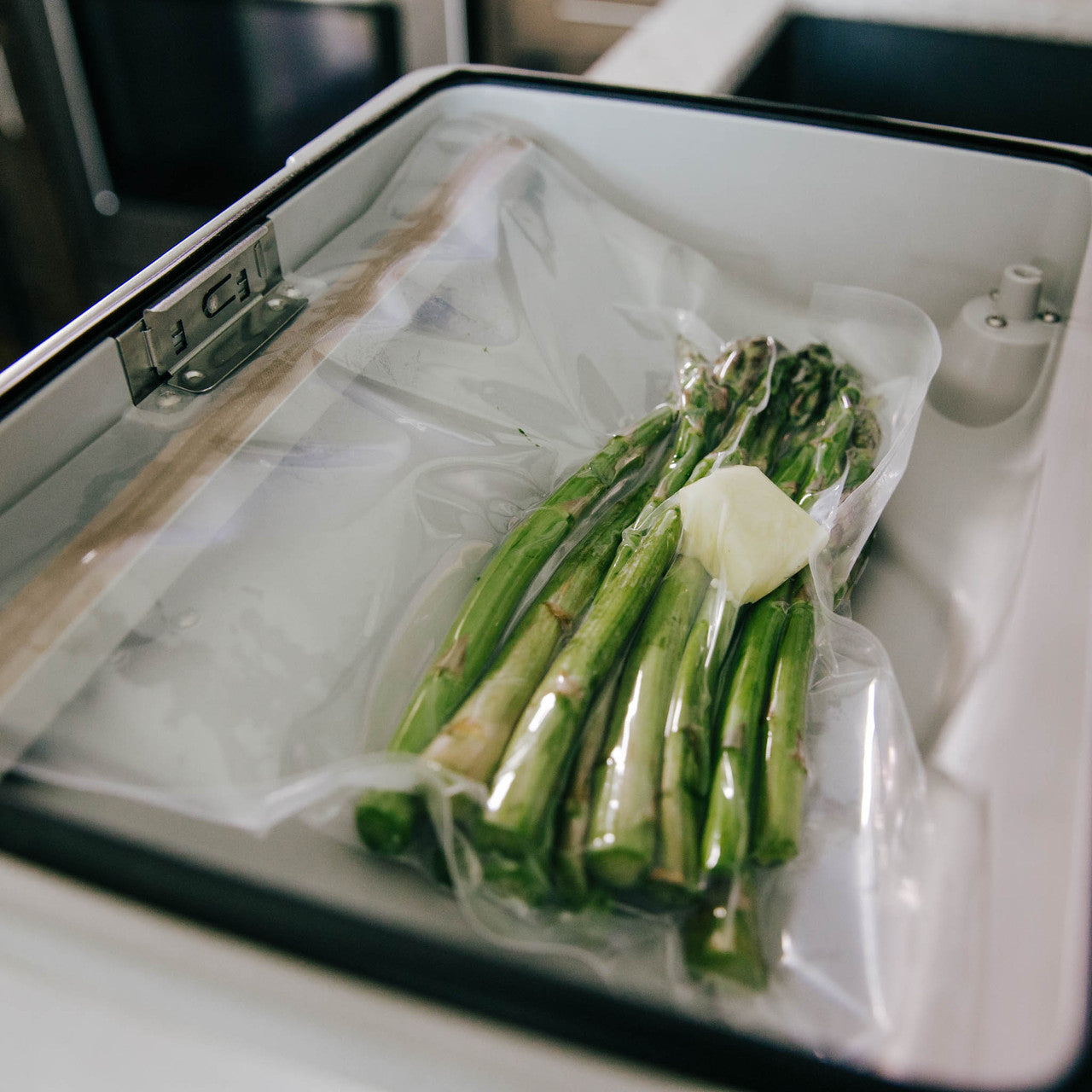 Detailed shot of Asparagus vacuum sealed with butter.