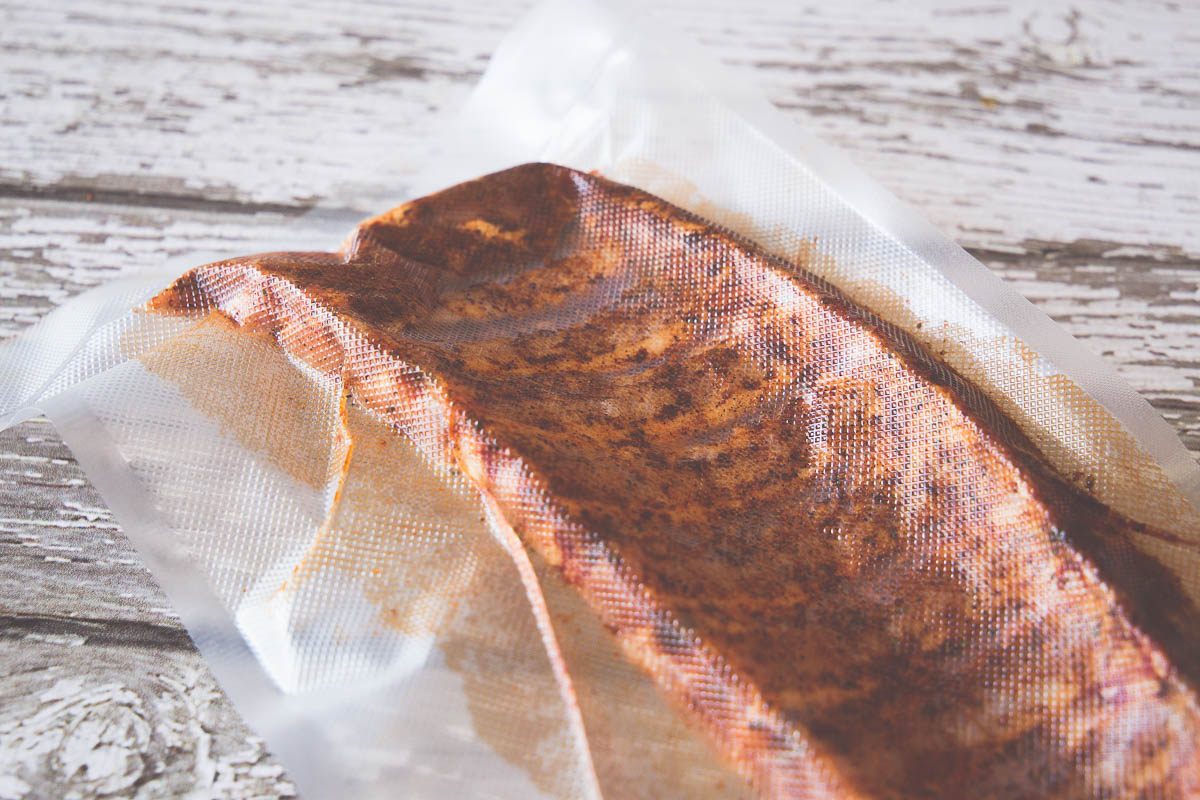 Pork ribs in a vacuum sealed bag with rub to infuse flavor