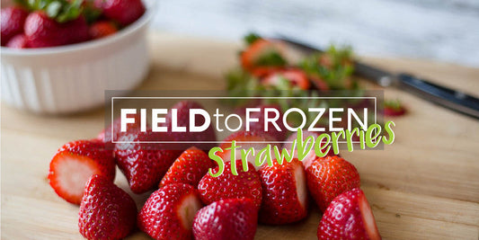 Fresh strawberries on a cutting board, prepped for vacuum sealing and freezing to prevent spoilage in summer.