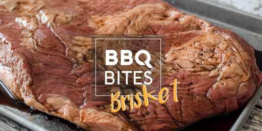 Raw marinated beef brisket on a tray with 'BBQ Bites Brisket' text, ready for vacuum sealing before smoking.