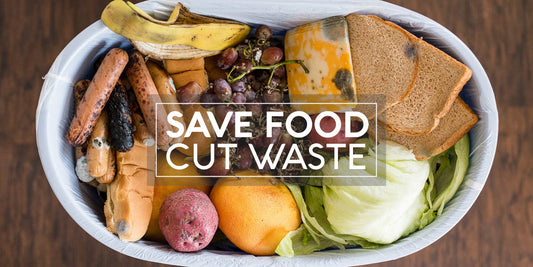 Spoiled fruits, vegetables, and bread in a bin with 'Save Food Cut Waste' message to promote food waste reduction.