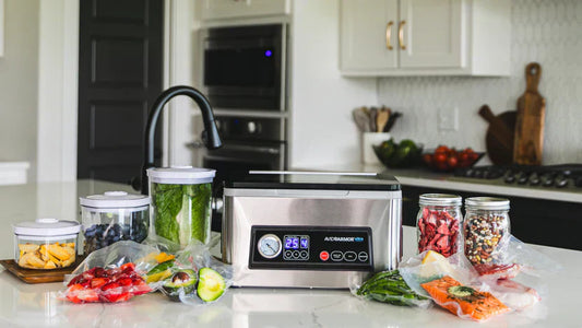 Avid Armor vacuum sealer on kitchen counter with vacuum sealed vegetables fruits and jars