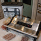 Vacuum sealer on a kitchen counter with food packages and a cooler in the background.