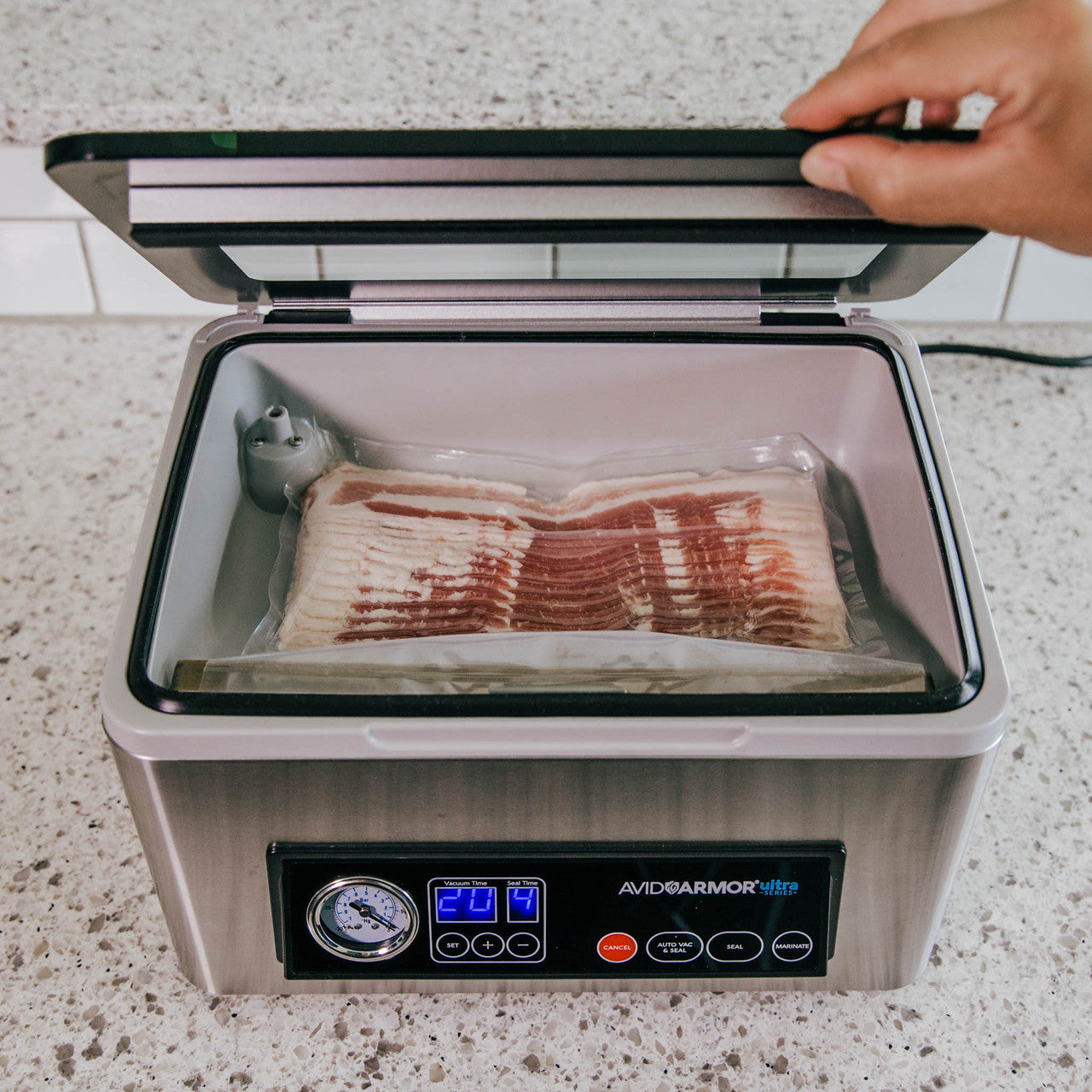 Avid Armor's USV20 chamber vacuum sealer features a slow close hinges on the lid.