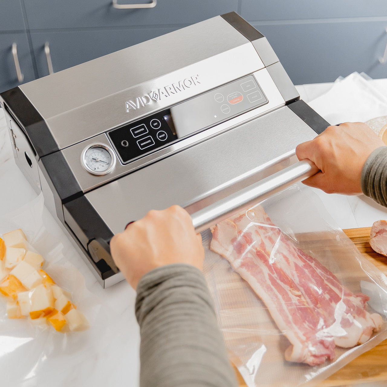A420 vacuum sealer with lid locking handle sealing thick cut sliced bacon in Avid Armor vac bags