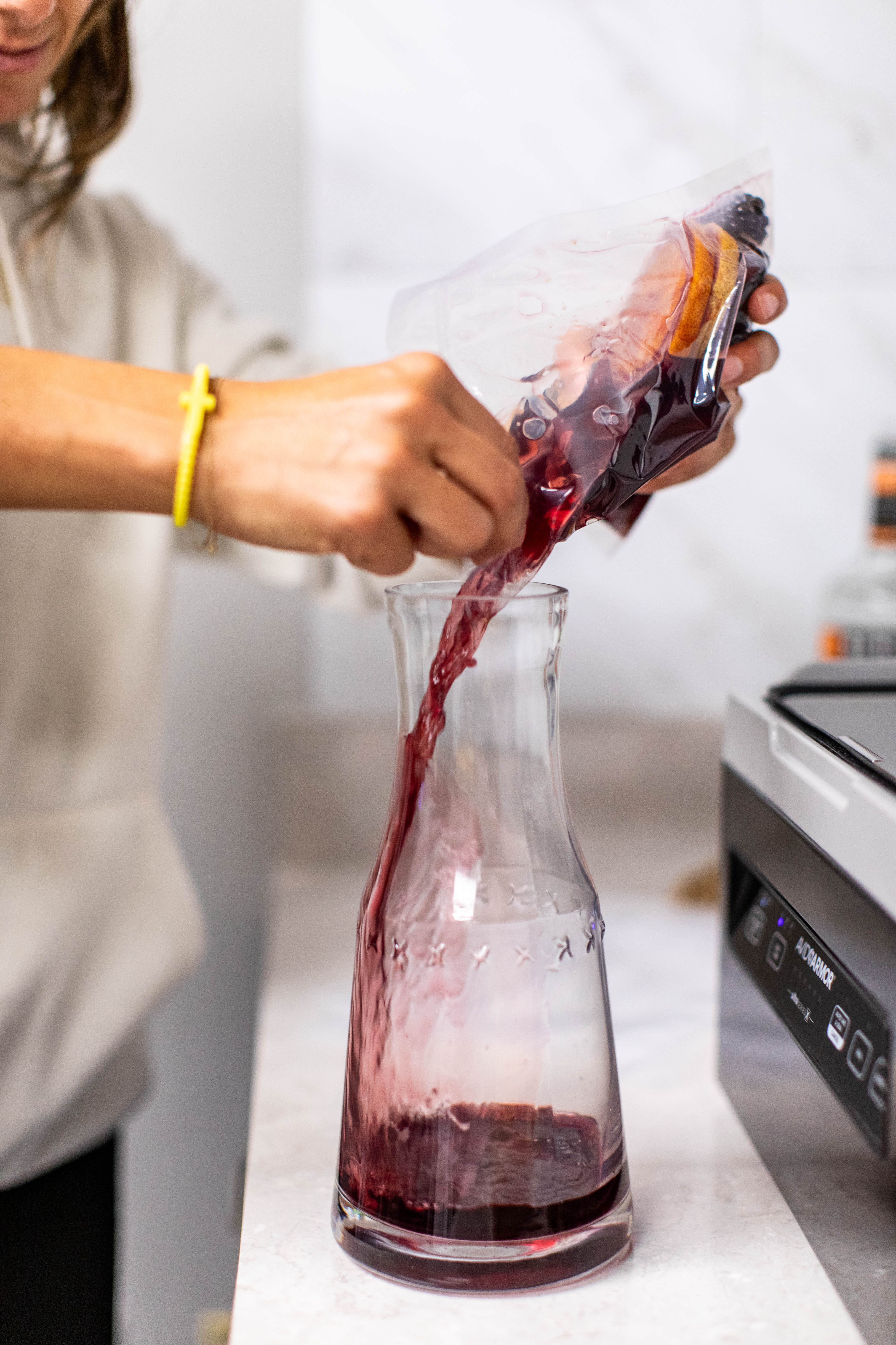 Pouring Red Wine into Carafe