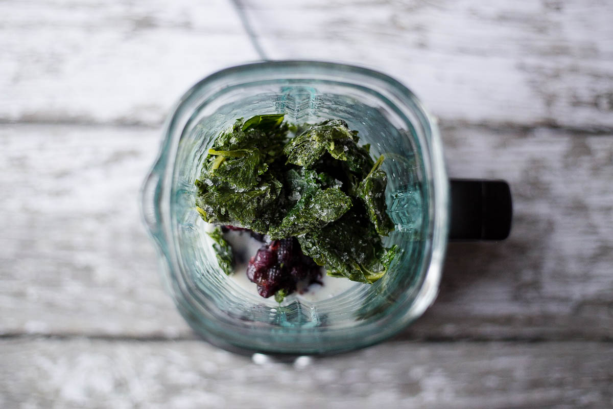 Add frozen kale to blender. Break up into smaller pieces to make blending easier.