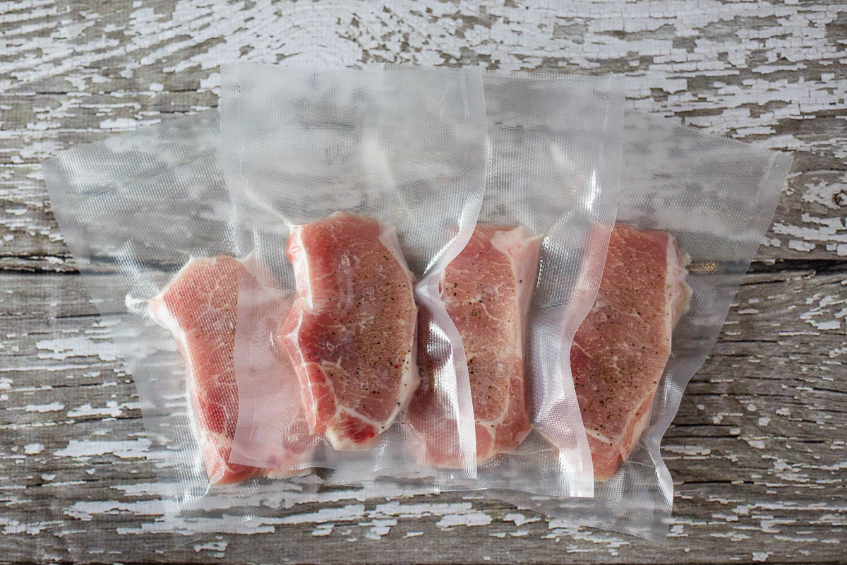 Single serving pork chops vacuum sealed in Avid Armor vacuum sealer bags ready for sous vide cooking
