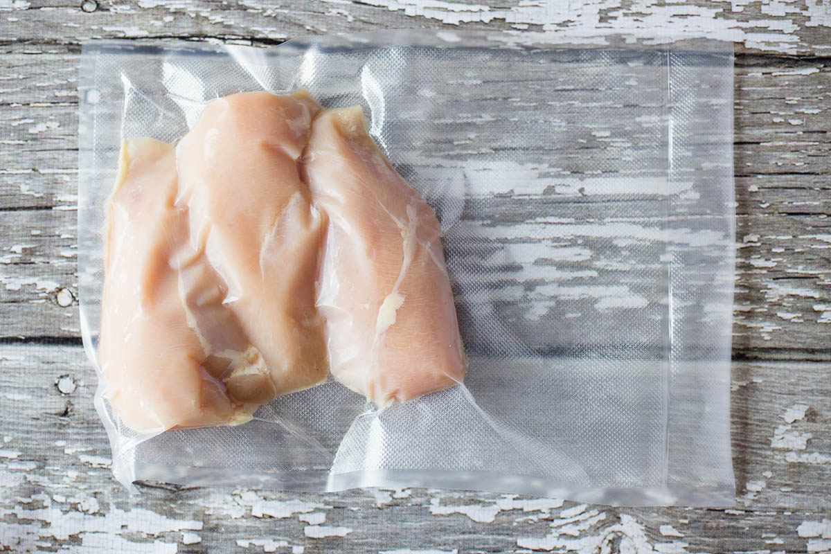 Avid Armor gallon size vacuum bag with 3 chicken breasts