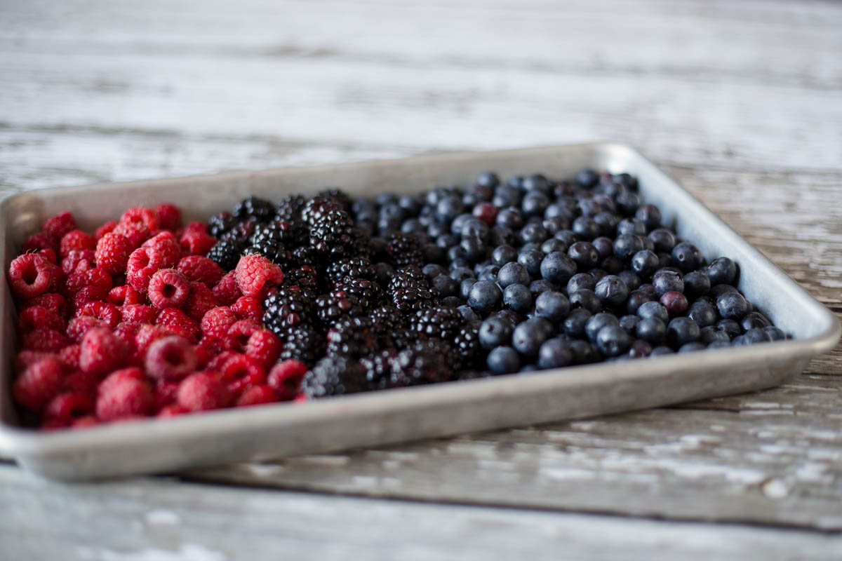 Lay berries on a cookie sheet for fast freezing