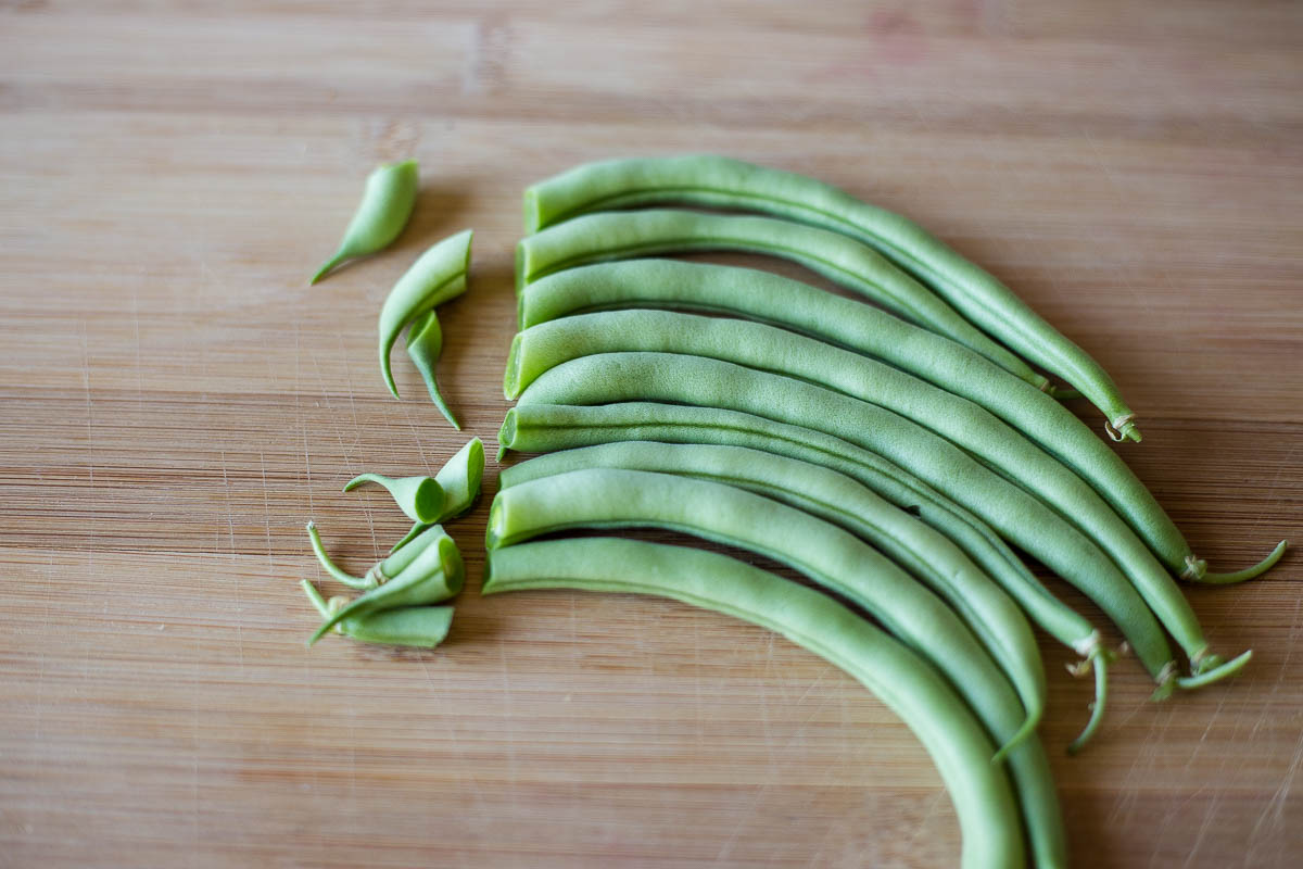 Cutting the ends off of fresh garden green beans