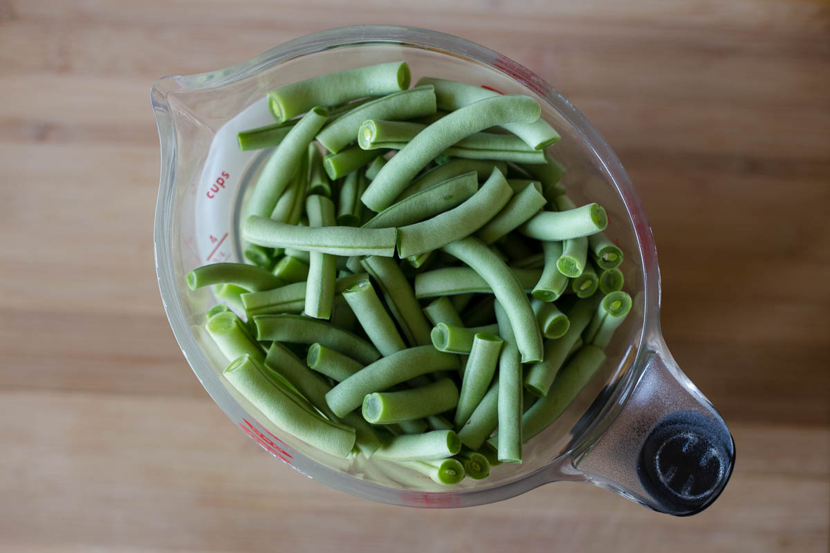 Measure out 4 cups of green beans to fill vacuum quart size food vacuum bag
