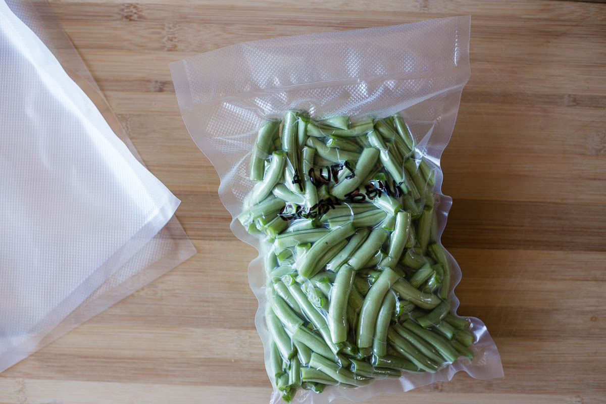 Green beans that have been vacuum sealed to be stored long term in the freezer for up to 3 years
